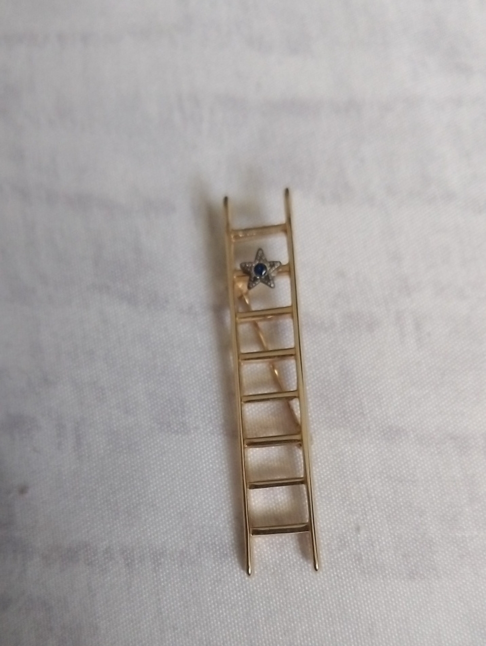 Gold-tone Ladder Pin with Blue Stone Star Accent
